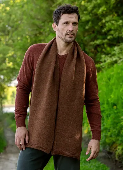 Personalized wool cashmere scarf in chestnut brown, made in Ireland, worn with rust sweater in forest backdrop